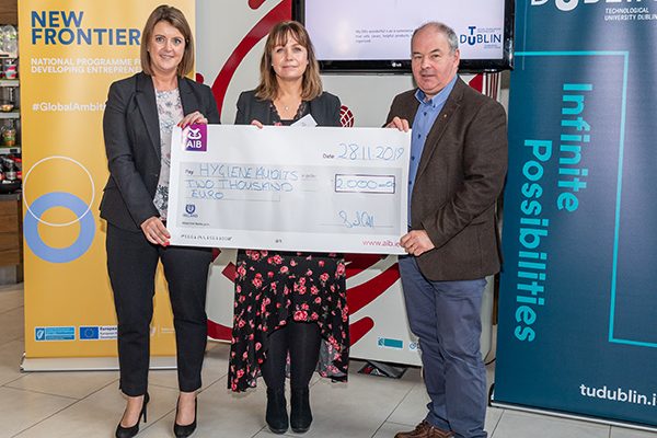 AIB Supporting Start-up Award winner Glenda Hahn (Hygiene Audits) recieves a cheque for €2000 from AIB representative and David McDonnell (Synergy Manager) at the 2019 New Frontiers Phase 2 Showcase Event in the Synergy Centre at TU Dublin.