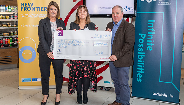 AIB Supporting Start-up Award winner Glenda Hahn (Hygiene Audits) recieves a cheque for €2000 from AIB representative and David McDonnell (Synergy Manager) at the 2019 New Frontiers Phase 2 Showcase Event in the Synergy Centre at TU Dublin.